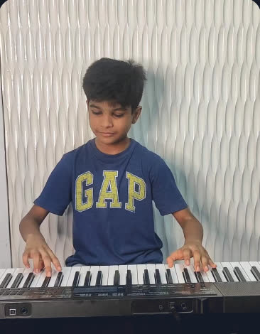 Young student playing keyboard